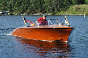 Photo courtesy of DVS1mn via Flickr Man riding a classic wooden boat